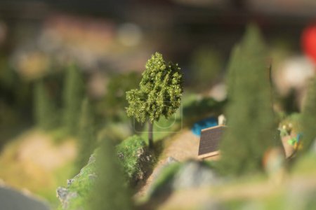 Photo for "Small trees. Model of mountainous terrain and forests. Toy world." - Royalty Free Image