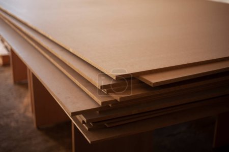 Photo for "Boards are stacked. Plywood sheet. Joinery. They made furniture production. Building material in garage. Raw wood." - Royalty Free Image