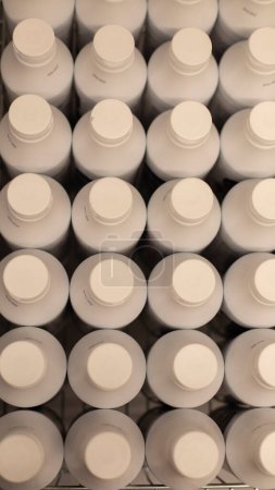 Photo for "White plastic bottles top view. Lots of milk bottles." - Royalty Free Image