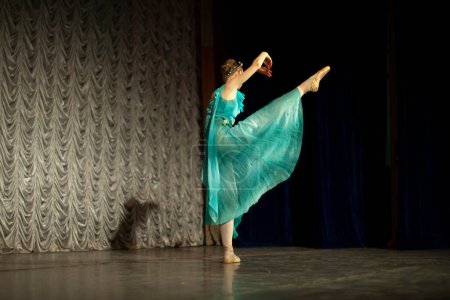 Photo for Ballerina dances. Dance lesson on stage. Girl in dress. - Royalty Free Image