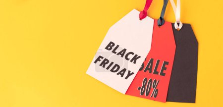 Photo for "banner with three paper labels with the text black Friday sale written in it against a yellow background. Black Friday concept." - Royalty Free Image