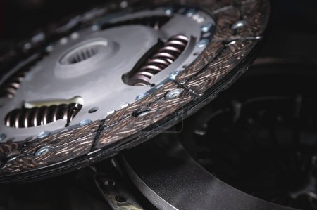 Foto de "Close-up clutch disc of a car lies on metal parts contrast shot" - Imagen libre de derechos