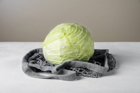 Photo for "White cabbage lie on the surface in environmentally friendly bag" - Royalty Free Image