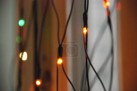 Photo for "LED lights garland on the window." - Royalty Free Image