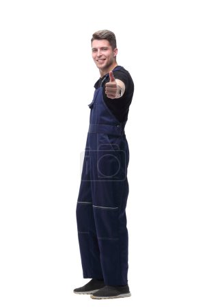 Photo for "smiling man in overalls showing thumb up .isolated on white" - Royalty Free Image