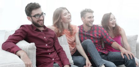 Photo for Group of smiling young people sitting on the couch - Royalty Free Image