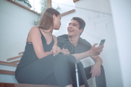 Photo for "happy young couple watching videos on smartphone." - Royalty Free Image