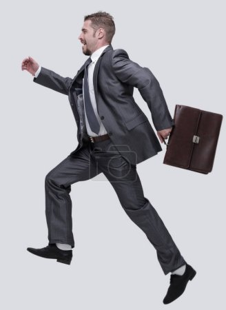Photo for "side view.cheerful businessman with briefcase stepping forward" - Royalty Free Image