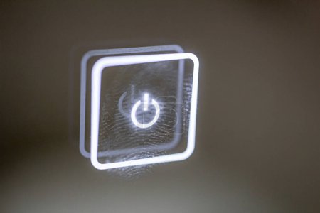 Foto de Un botón táctil brillante manchado con marcas de dedos. apagar. - Imagen libre de derechos