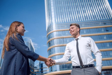 Photo for Young businessman meeting a young professional with a handshake. - Royalty Free Image
