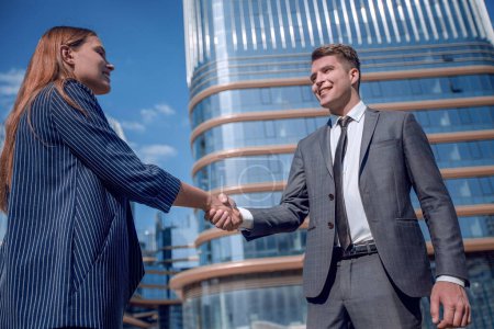 Photo for Friendly young businessman shaking hands with his business partner. - Royalty Free Image
