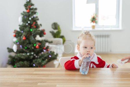 Photo for Child with cochlear implant hearing aid in christmas living room copy space - deafness treatment and medical innovative technologies - Royalty Free Image