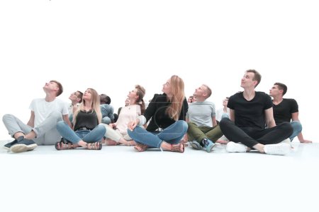 Photo for Group of young people sitting on the floor in a bright room. - Royalty Free Image