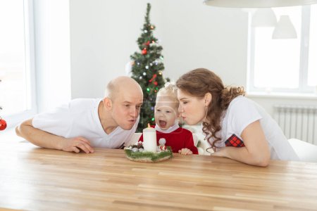 Foto de Baby child with hearing aid and cochlear implant having fun with parents in christmas room. Deaf , diversity and health concept - Imagen libre de derechos