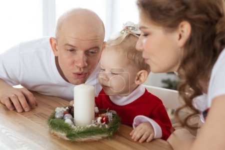 Photo for Baby child with hearing aid and cochlear implant having fun with parents in Christmas room. Deaf , diversity and health concept - Royalty Free Image