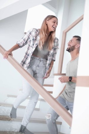 Photo for "happy couple on the stairs in their new apartment." - Royalty Free Image
