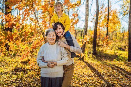 Photo for Grandmother and adult grandson hugging in autumn park - Royalty Free Image