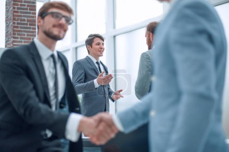 Photo for Happy young businessman shaking hands with his business partner - Royalty Free Image