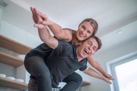 Photo for Young married couple having fun in their new kitchen - Royalty Free Image