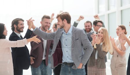 Photo for Cheerful employees congratulating a colleague on the promotion - Royalty Free Image