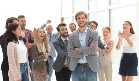 Photo for Happy young business man standing among colleagues - Royalty Free Image