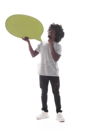 Photo for "in full growth. curly-haired guy holding a speech bubble" - Royalty Free Image