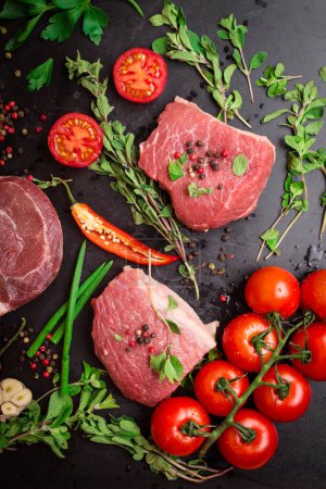 Photo for "Veal fillet on a dark background ready to roasting" - Royalty Free Image