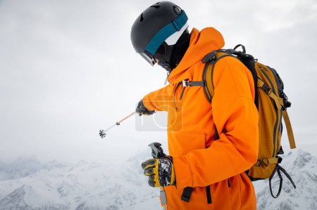 Foto de "Portrait of a young adult in a ski helmet and goggles, with high" - Imagen libre de derechos