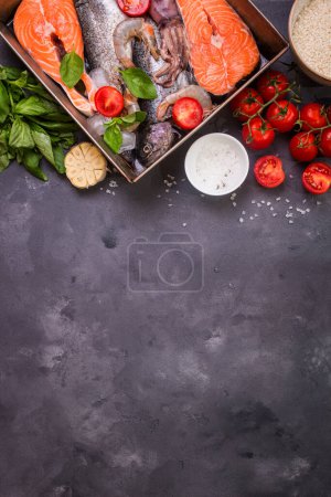 Photo for "Assorted fish and seafood on dark background" - Royalty Free Image