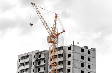 Photo for A big yellow crane constructing a new high rise - Royalty Free Image
