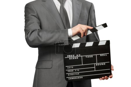 Photo for Man holding movie clapper board on white - Royalty Free Image