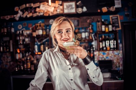 Photo for Girl barman mixes a cocktail in the brasserie - Royalty Free Image