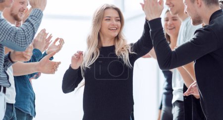 Photo for Happy business team giving each other a high five. - Royalty Free Image