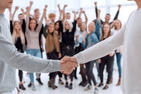Photo for Young business people shaking hands with each other - Royalty Free Image