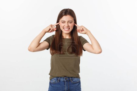 Photo for Closeup portrait of a young angry woman covering her ears, stop making that loud noise it's giving me a headache, isolated on white background. - Royalty Free Image