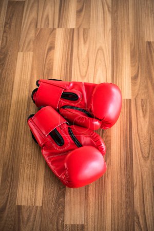 Photo for Red boxing gloves on a wood background. - Royalty Free Image
