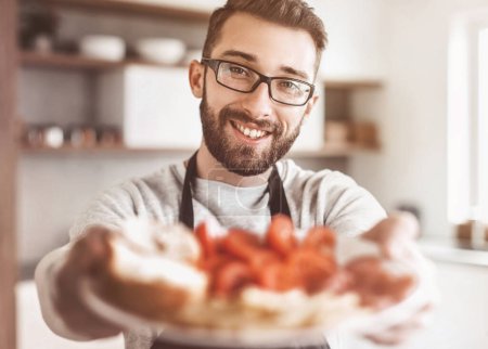 Photo for Plate of sandwiches in the hands of an attractive man - Royalty Free Image