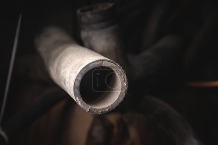 Foto de "Rubber pipes and hoses leading from the car radiator to the engine, view of the engine from below. old worn rubber car cooling system hoses" - Imagen libre de derechos