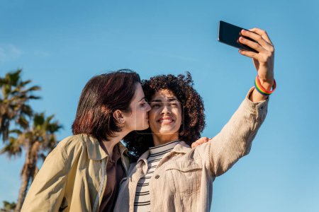 Photo for Interracial young couple of women doing a selfie - Royalty Free Image