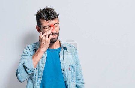 Photo for "Person with pain touching nose. A person with nasal bridge pain, Man with nasal bridge headache. Sinus pain concept" - Royalty Free Image