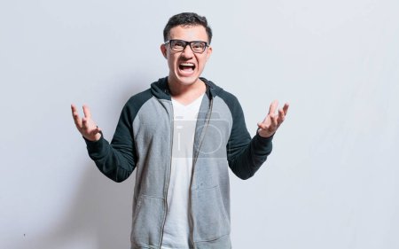 Photo for "Young man with open hands screaming angry to the camera, Irritated person screaming with open arms, Stressed people screaming with open hands" - Royalty Free Image