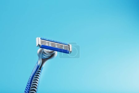 Photo for "Shaving machine with three blades on a blue background close-up free space" - Royalty Free Image