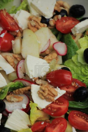 Photo for "Mixed salad: goat cheese, pear, olives and walnuts" - Royalty Free Image