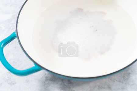 Photo for Cleaning cast iron blue enameled braiser - Royalty Free Image