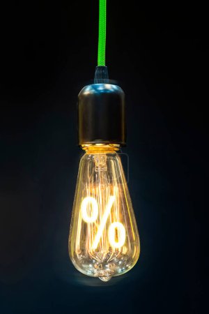 "Bulb with glowing percent mark inside of it, creativity concept"