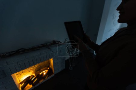 Téléchargez les photos : Homme tenant tablette numérique dans l'obscurité - en image libre de droit