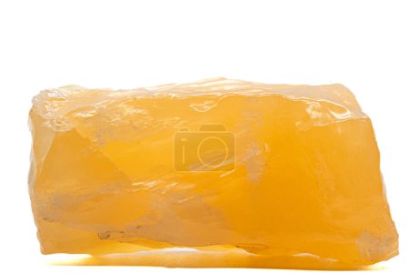 Foto de Macro focused raw shiny semi-transparent vibrant orange, calcite stone, bright orange carbonate crystal isolated on a white surface background - Imagen libre de derechos