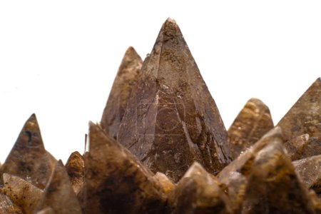 Macro focused raw natural brown sharp spiked calcite, calcite stone, natural sharp and brown carbonate crystal geode isolated on a white surface background