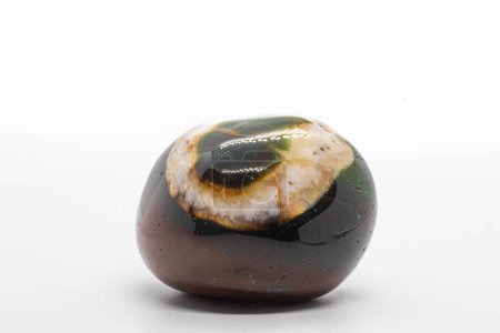 Macro tumbled dark green and brown sardonyx crystal, agate crystal with a circle of white calcite mineral isolated on a white surface background