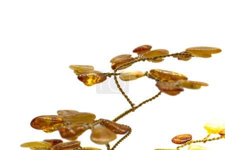 Photo for Vibrant yellow and orange polished amber crystal and copper wire tree on a blue chalcedony mineral base macro isolated on white surface - Royalty Free Image